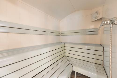 a walk in closet with white and gray stripes at Alpenhof in Lermoos