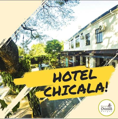 a sign that reads hotel chicago in front of a building at Hotel Chicala salgar in Puerto Salgar