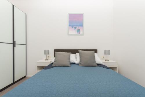 a bedroom with a blue bed with two night stands at Villa Simon in Makarska