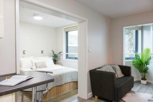 a bedroom with a bed and a desk and a chair at Modern Studios and Private Bedrooms with Shared Kitchen at Chapter Islington in London in London