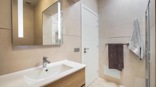 a white bathroom with a sink and a mirror at Etti - Paradise Rosa Maria in Pájara