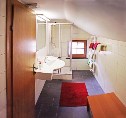 a bathroom with a sink and a bath tub at Ferienwohnungen Kirchweger in Wagrain