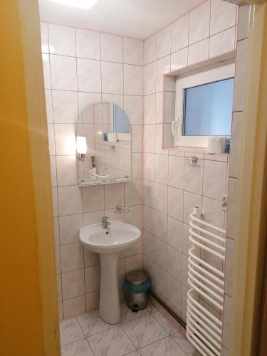 a bathroom with a sink and a mirror at Pokoje Pod Łukami in Solina