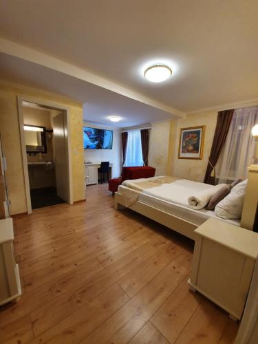 a bedroom with a bed and a living room at Esos Hotel Quelle in Bad Ragaz