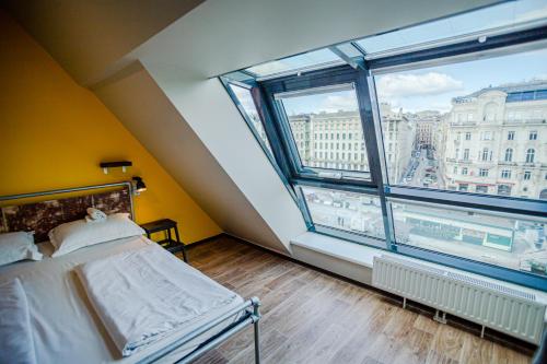 a bedroom with a bed and a window at Wombat's City Hostel Vienna Naschmarkt in Vienna