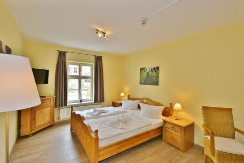 a bedroom with a large bed and a window at Maria Aurora in Quedlinburg