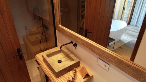 a bathroom with a sink and a mirror at Santa Llúcia Rupit in Rupit
