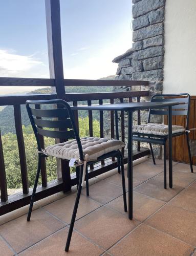two chairs sitting on a balcony with a view at Santa Llúcia Rupit in Rupit