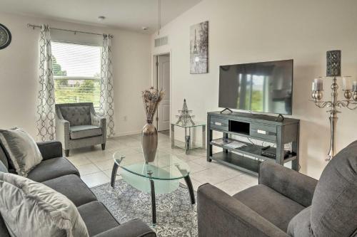 a living room with a tv and a couch and a table at Sunny Abode Less Than 1 Mi to Peace River Preserve! in Port Charlotte