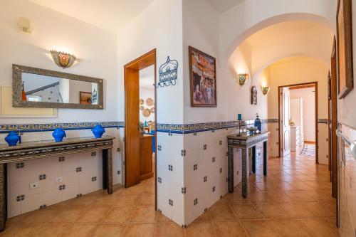 a large room with a fireplace and a mirror at Villa Oasis Galé - Luxury Villa with private pool, AC, free wifi, 5 min from the beach in Albufeira