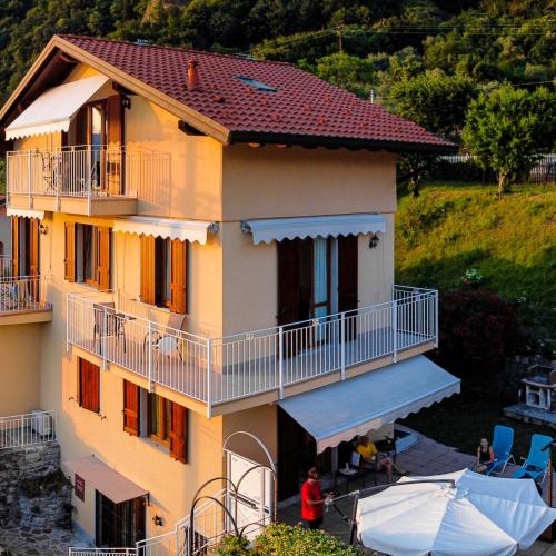 a large house with a balcony and a yard at B&B-FORESTERIA Casa Della Musica Lake Como in Mandello del Lario