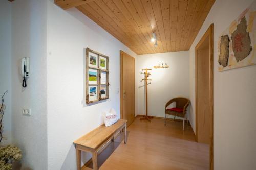 a hallway with a wooden table in a room at Ferienbauernhof Oberhauser in Schoppernau