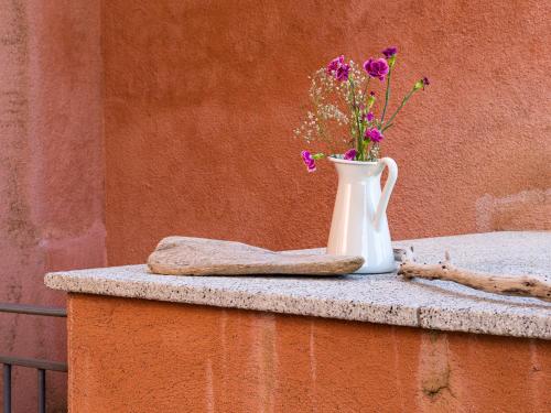 a vase with flowers in it sitting on a table at Myrsine 7S - Klodge in Murta Maria