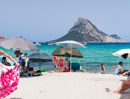 a group of people on a beach with umbrellas at Myrsine 7S - Klodge in Murta Maria