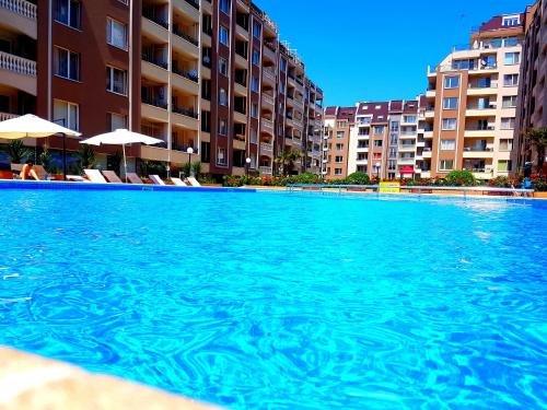 a swimming pool in front of some apartment buildings at Studios Zornitsa Burgas in Burgas