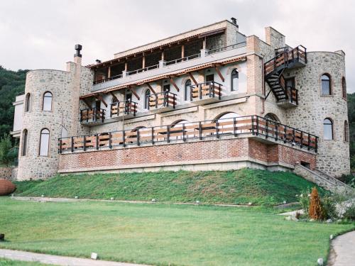 a large brick building with balconies on it at Babaneuris Marani in Babaneuri