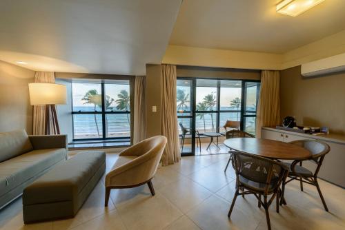 a living room with a couch and a table at Hardman Praia Hotel in João Pessoa