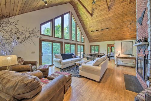 a large living room with couches and a fireplace at Sebago Lake Gem on Private Cove with Boat Dock! in Raymond