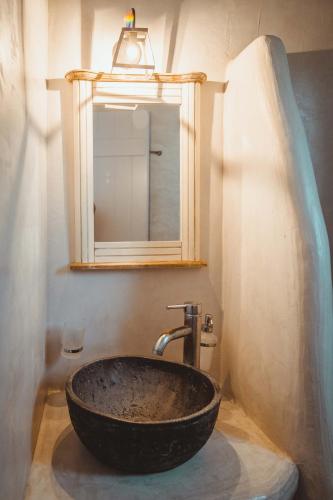 a bathroom with a black sink and a mirror at Annio studios in Plaka