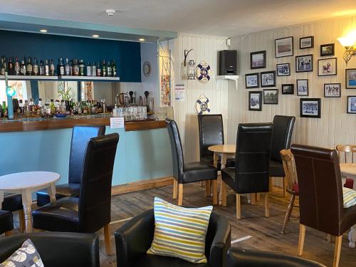 a bar with chairs and tables in a restaurant at Marlborough Hotel in Shanklin