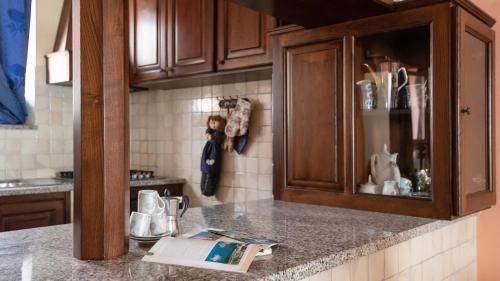 a kitchen counter with a doll hanging on the wall at Welcomely - Pan di Zucchero 12 - Nebida in Nebida