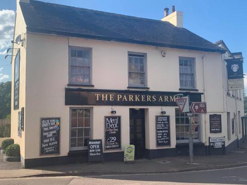 a white building with signs on the front of it at The Parkers Arms - The home of Cattlemans Steakhouse in Paignton