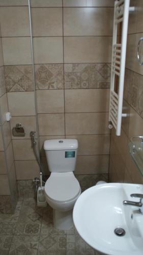 a bathroom with a white toilet and a sink at A Painter's House in Plaka in Athens