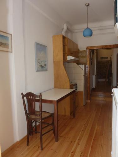 a kitchen with a table and a chair in a room at A Painter's House in Plaka in Athens