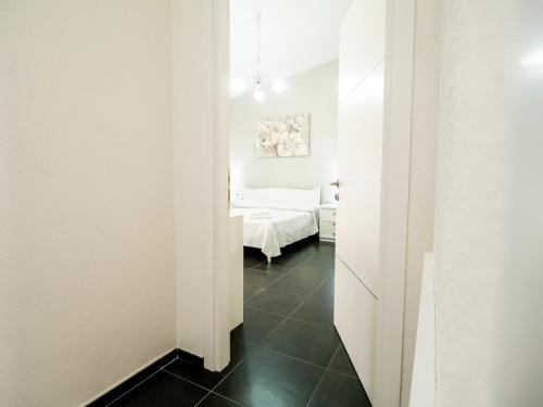 a hallway with a bedroom and a bed in a room at SweetHome - MORADA in Torpè