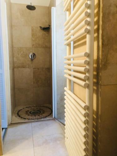 une salle de bain avec une douche avec une porte vitrée dans l'établissement Bel appartement bien placé au cœur de Cannes, à Cannes