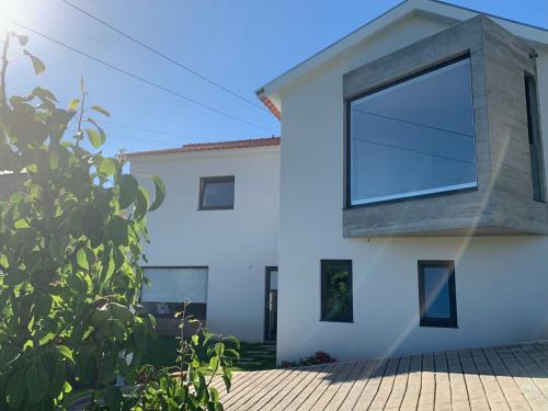 a house with a large window on the side of it at A Casa do Abílio em Alvarenga in Alvarenga