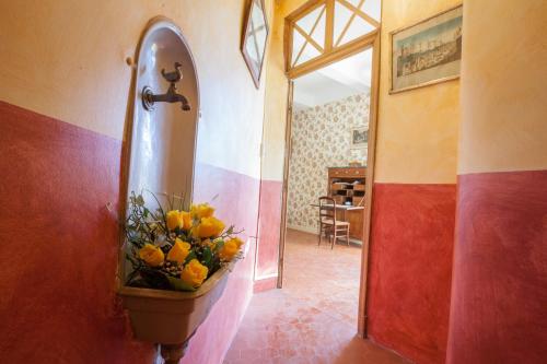 a bathroom with a vase of flowers on the wall at Chateau de Saint Martin in Taradeau
