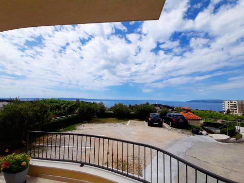 a balcony with a view of a parking lot at Apartments Akmadzic in Makarska