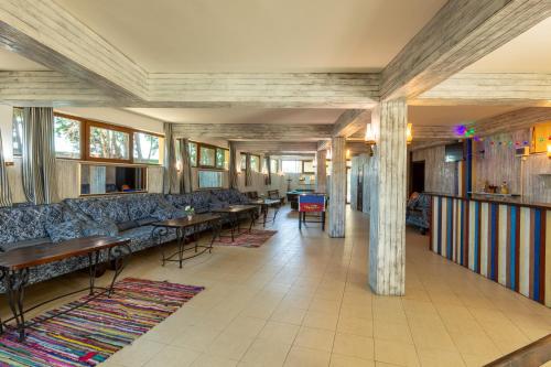 a lobby with couches and tables and windows at Hotel Julia in Sveti Vlas