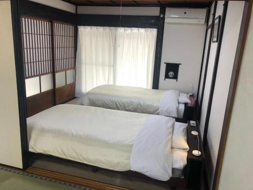 a bedroom with two beds and a mirror at Hatago Masara - Vacation STAY 30108v in Tanabe