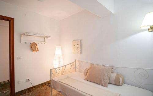 a white bedroom with a bed and a mirror at BENNÁSSAR 2 in Felanitx