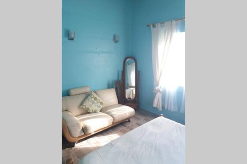 a living room with a couch and a window at A Peace of Paradise Apt nr Airport and Beach in Vieux Fort