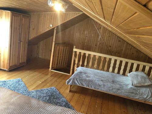 a room with a bed in a attic at Domek letniskowy na Mazurach in Giżycko