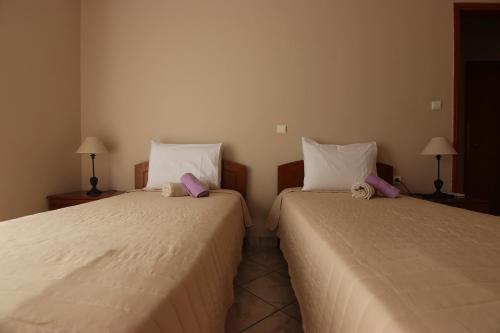two beds sitting next to each other in a room at Grammeno Seaside Studios in Palaiochóra