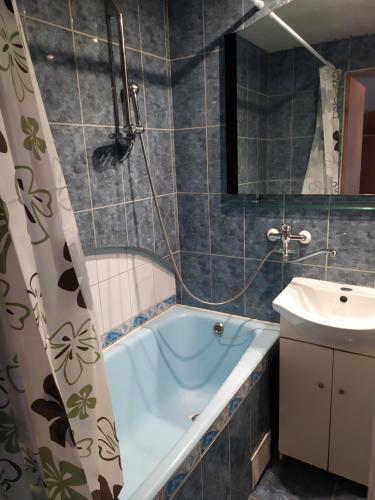 un baño con bañera y lavabo en Inzenieru 95 Apartments ., en Ventspils