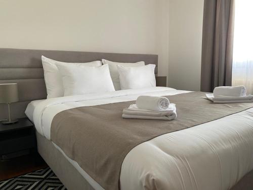 a bedroom with a bed with two towels on it at Apartman Luka in Vrnjačka Banja