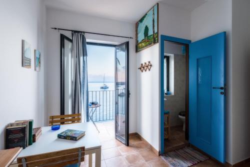 a room with a desk and a view of the ocean at Casa di Sale - Chianalea in Scilla