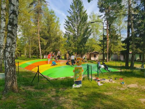 a park with people playing in a playground at Chatový tábor Malý Ratmírov in Malý Ratmírov