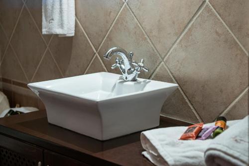 a white sink on a counter in a bathroom at Verekinthos Villas - Pool, Hot Tub, BBQ, Kids Playground, Stunning Mountain Views in Gerolakkos