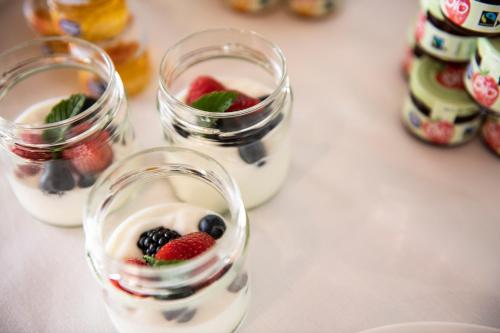 two glasses filled with fruit and yogurt on a table at Magari Estates Boutique Hotel in Colognola ai Colli
