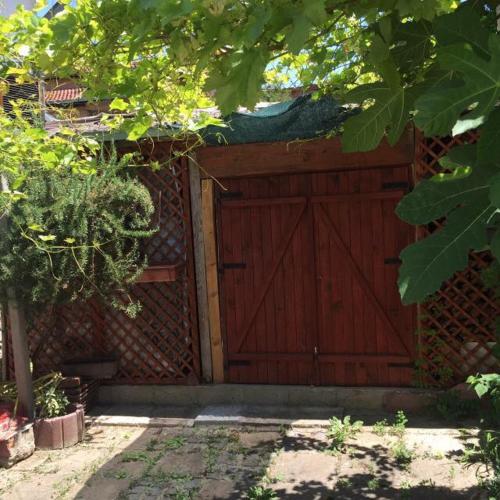 a wooden garage with a red door on a building at HOSTEL EMI in Kavadarci
