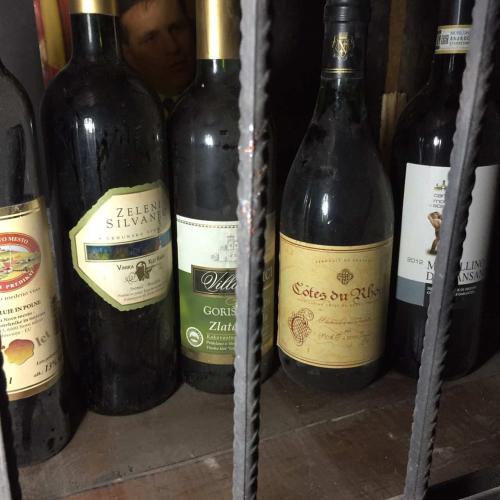 four bottles of wine sitting on a shelf at HOSTEL EMI in Kavadarci