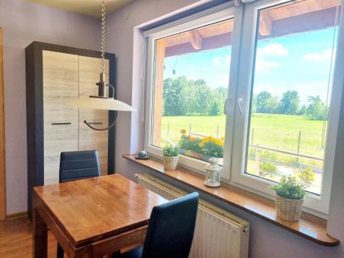 a dining room with a table and a large window at Woodland in Łagów