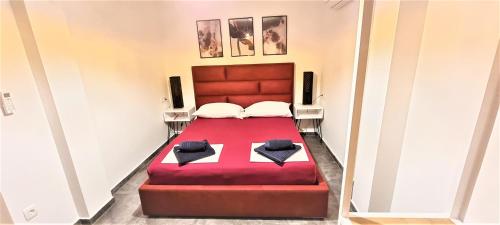 a bedroom with a red bed with two pillows at Villa Kajgo-Pag in Pag