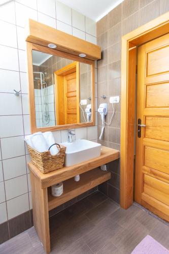 a bathroom with a sink and a mirror at Zajazd Gołębiowski in Lipsko